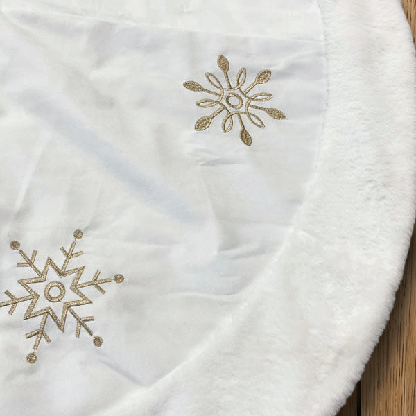a white blanket with gold snowflakes on it