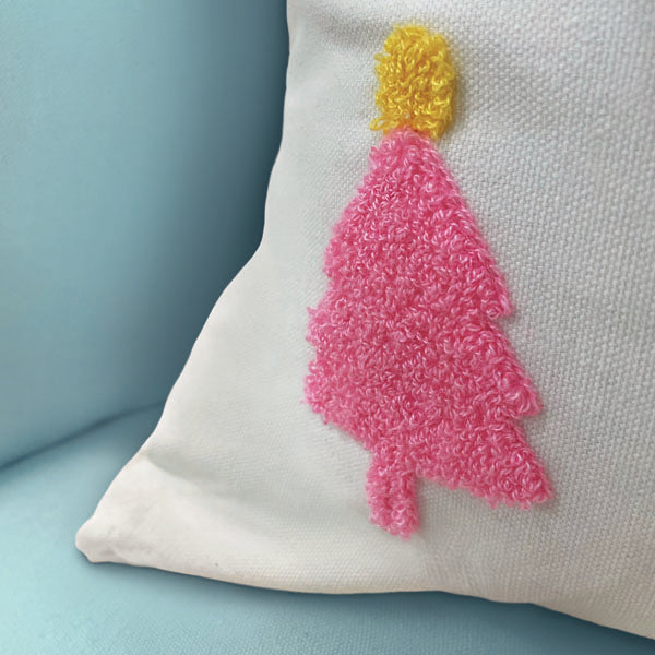 a pillow with a pink tree design