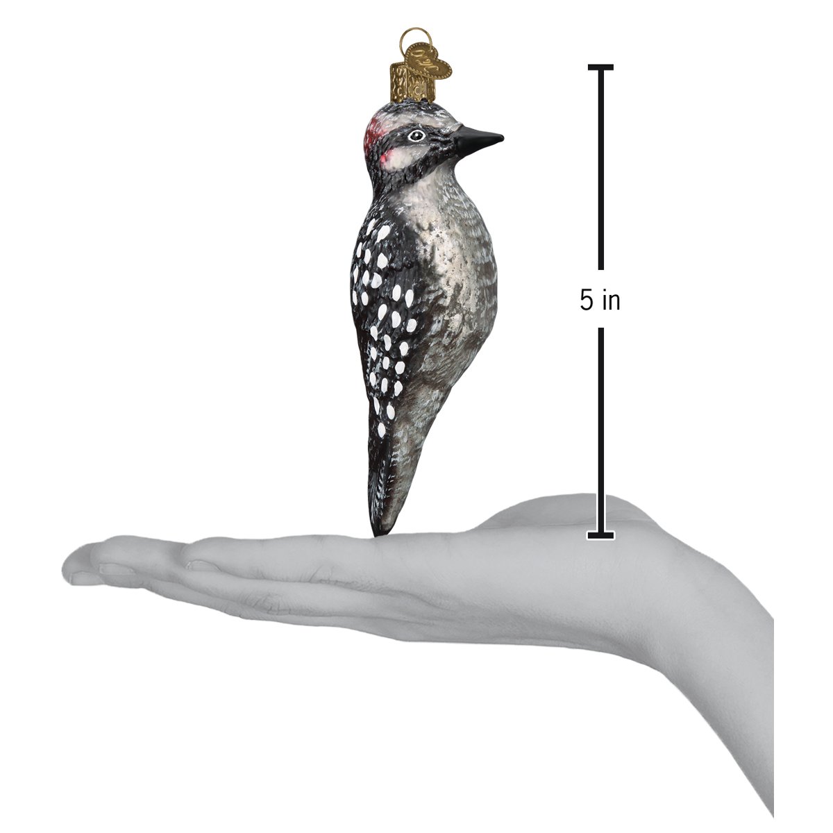 a hand holding a bird ornament