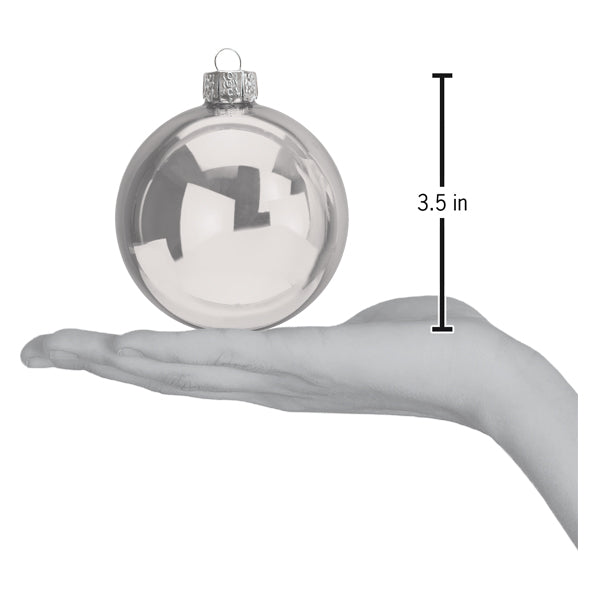 a hand holding a christmas ornament