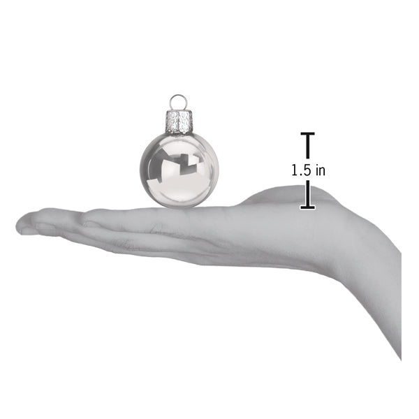a hand holding a christmas ornament