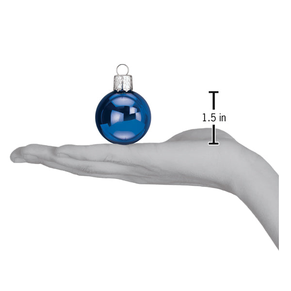 a hand holding a blue ornament