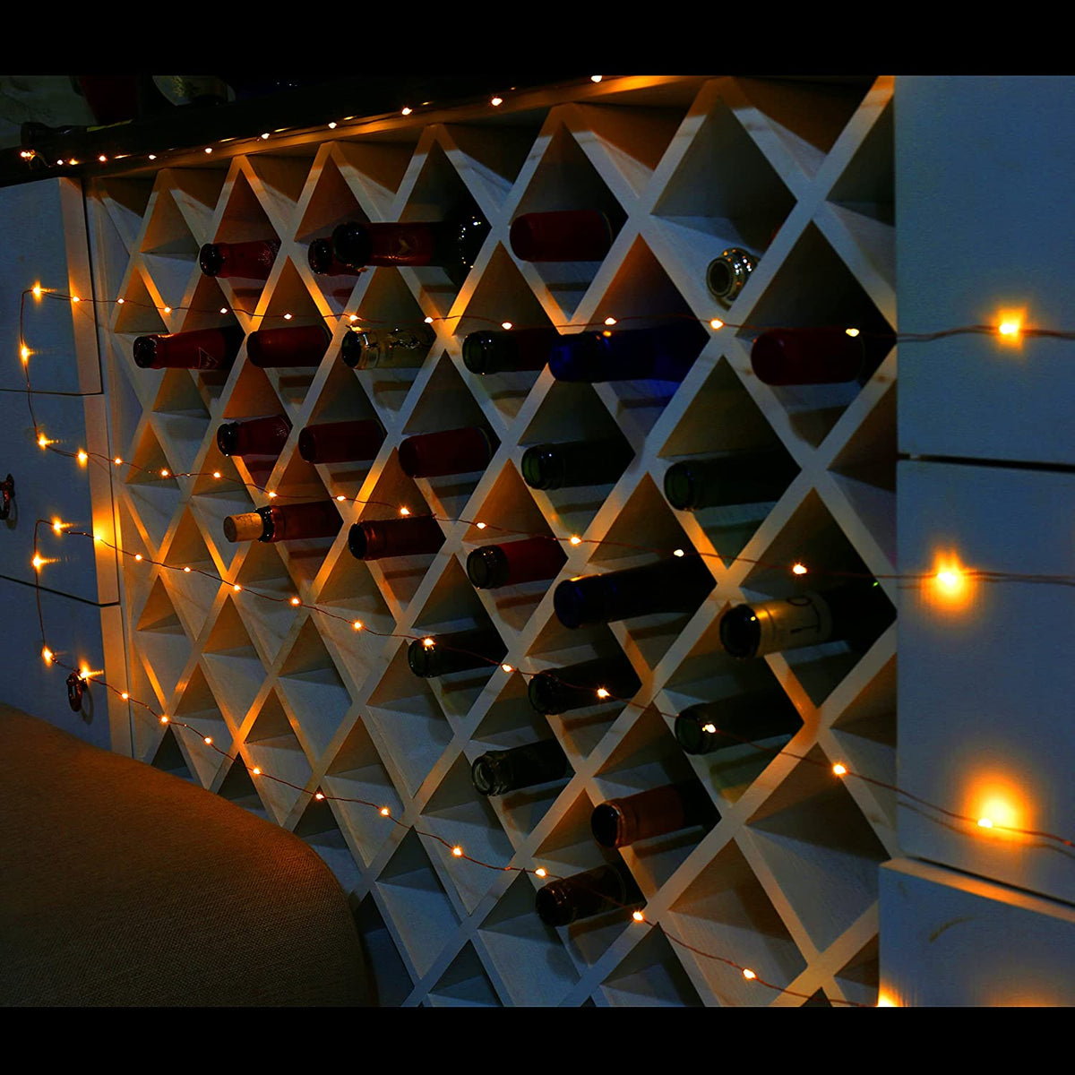 wine bottles on a shelf with lights