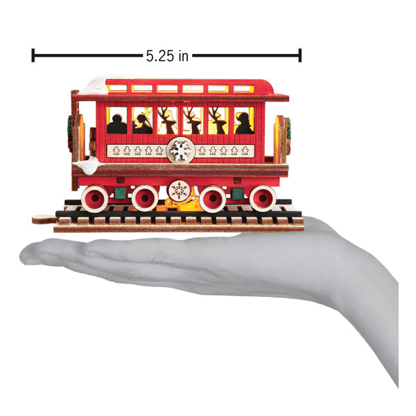 a hand holding a toy train