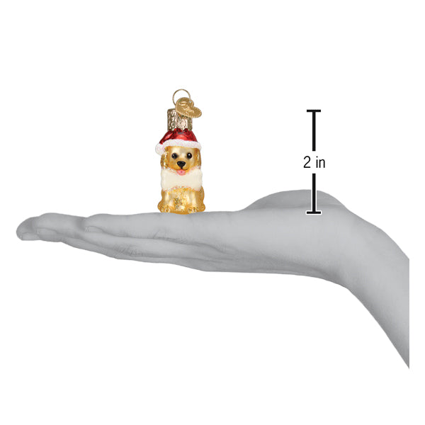a hand holding a small dog ornament