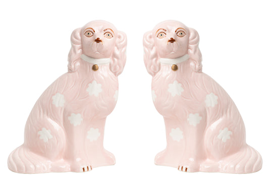a pair of pink dogs figurines