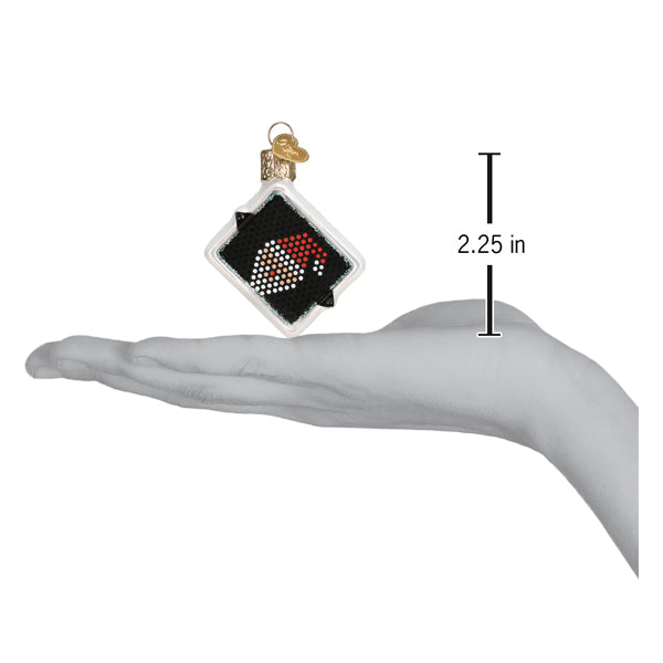 a hand holding a christmas ornament