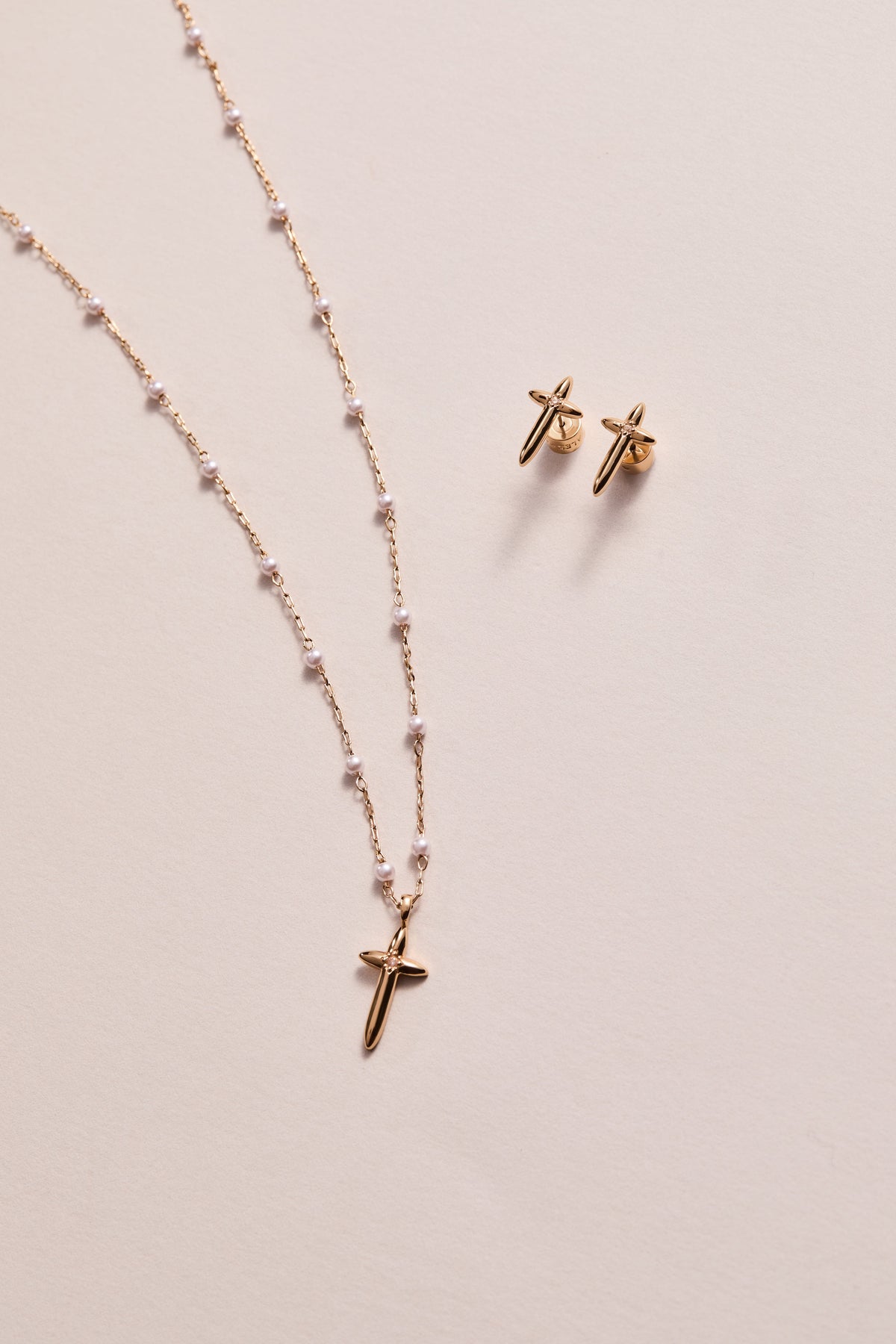 a gold necklace and earrings