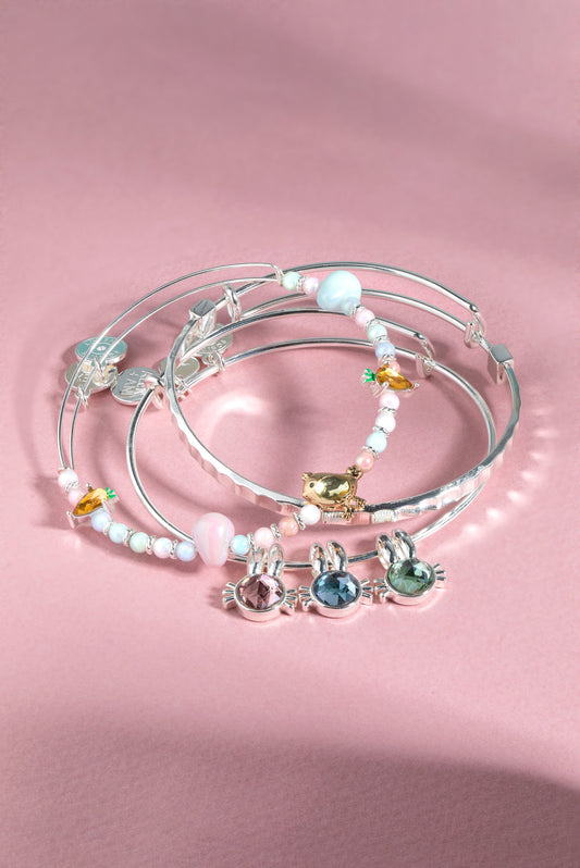 a group of bracelets on a pink surface
