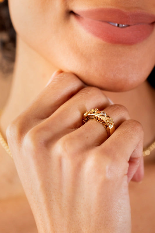 a close up of a woman's hand with a ring on her finger