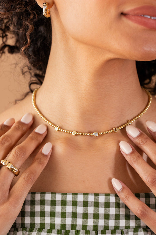 a woman wearing a necklace and ring
