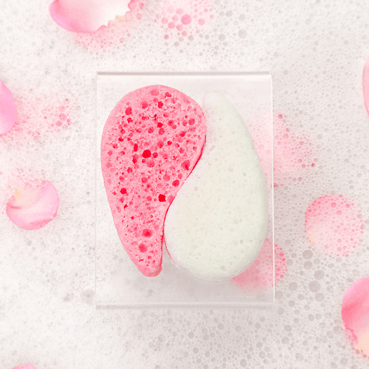a pink and white sponge in a clear container with pink petals
