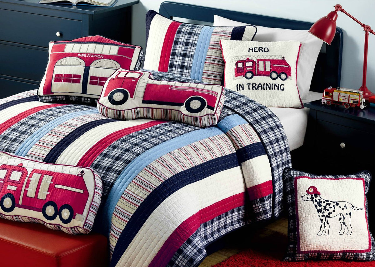 a bed with a firetruck pillow