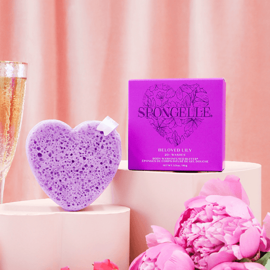 a purple heart shaped object next to a purple box and flowers