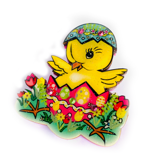 a yellow chick in an egg shaped egg