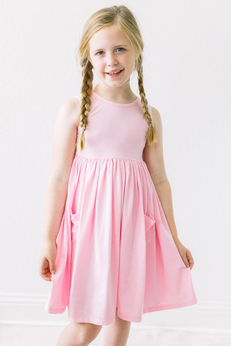 a girl in a pink dress