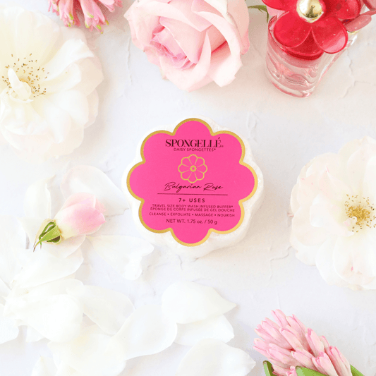 a pink and white flower shaped container with a pink label surrounded by white flowers