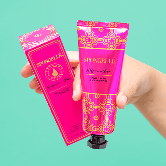 a hand holding a tube of cream