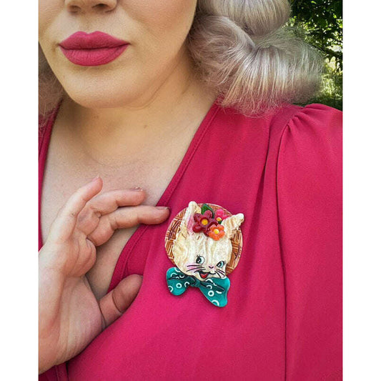 a woman wearing a cat brooch