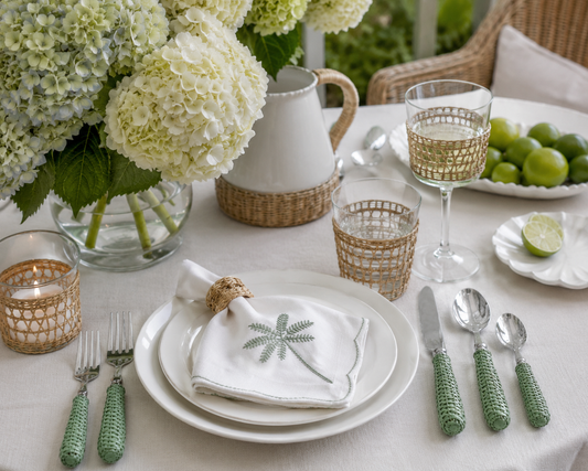 a table set with white and green decorations