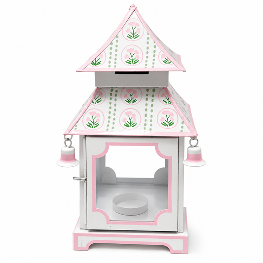 a pink and white object with a roof and bells