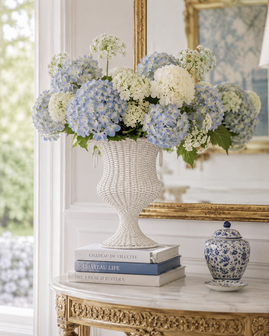 a vase of flowers on top of books