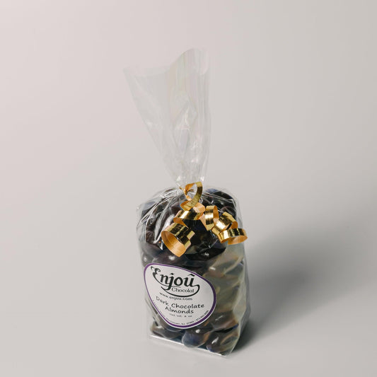 a bag of chocolate candies with gold bells