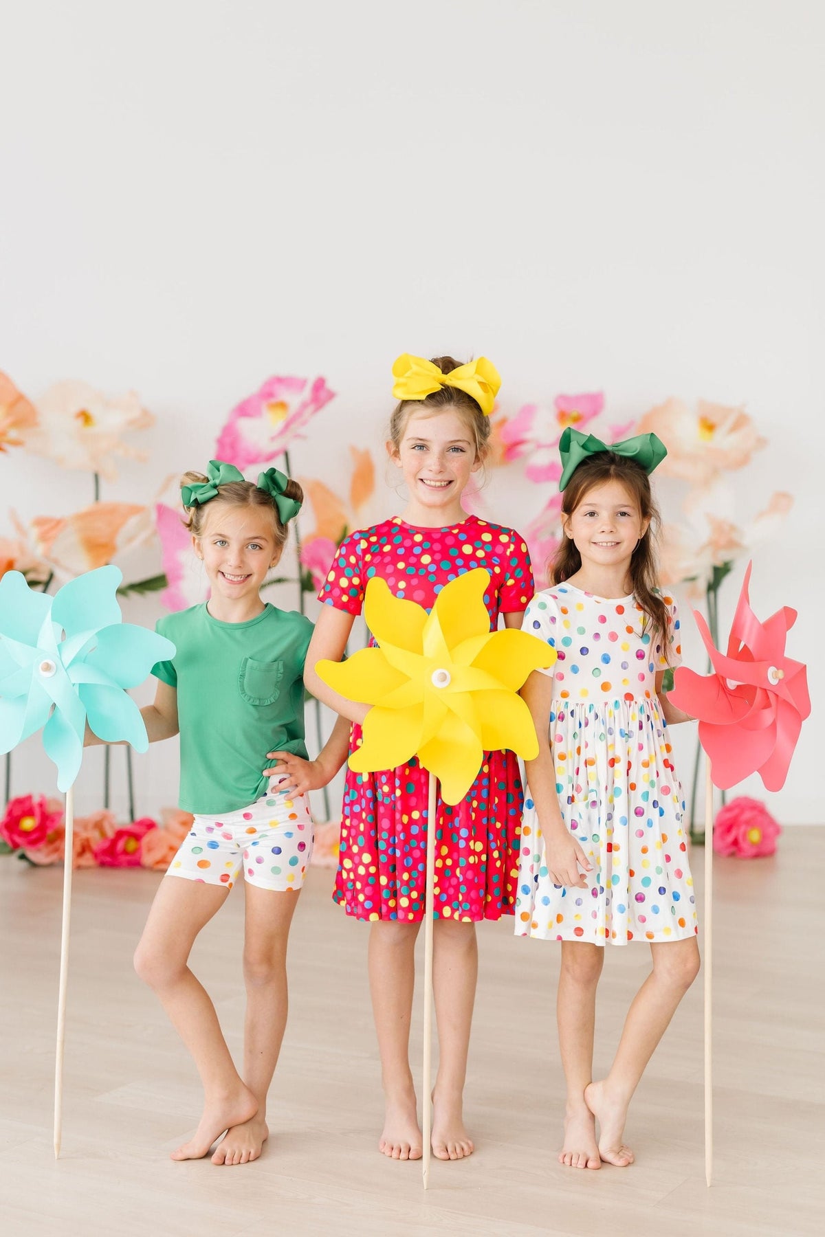 a group of girls holding pinwheels