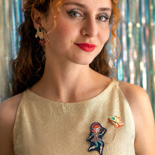 a woman with red hair and earrings