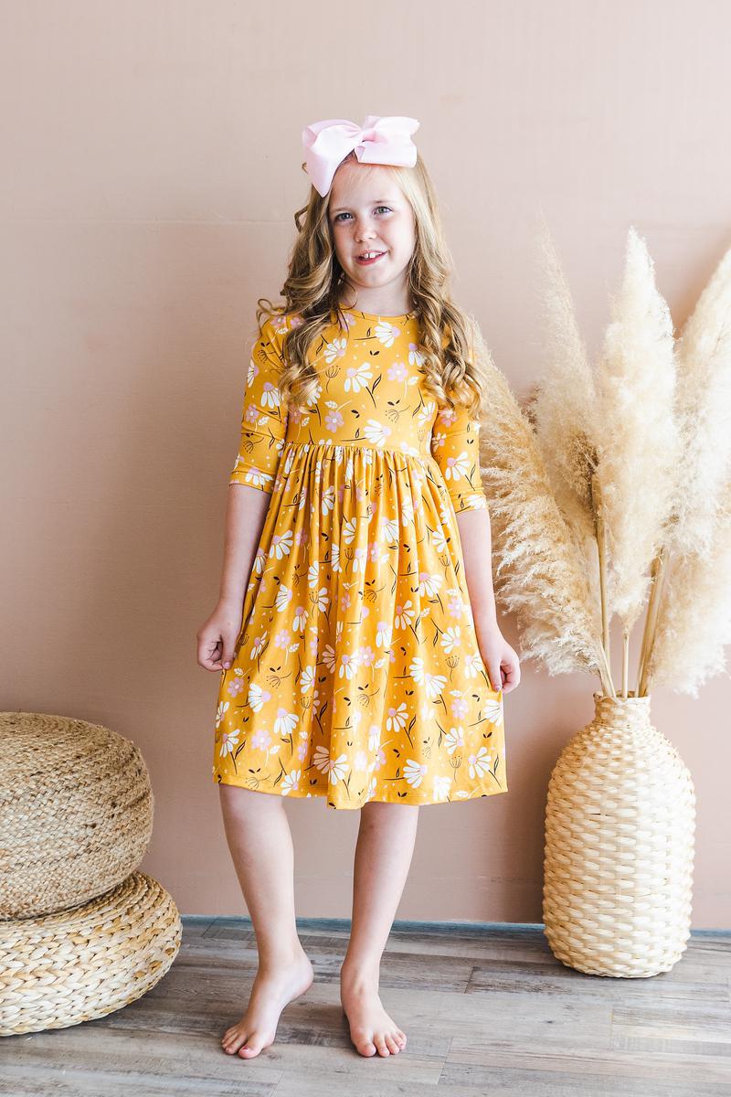 a girl in a yellow dress