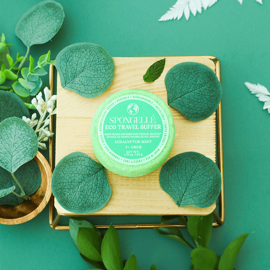 a green container with leaves around it