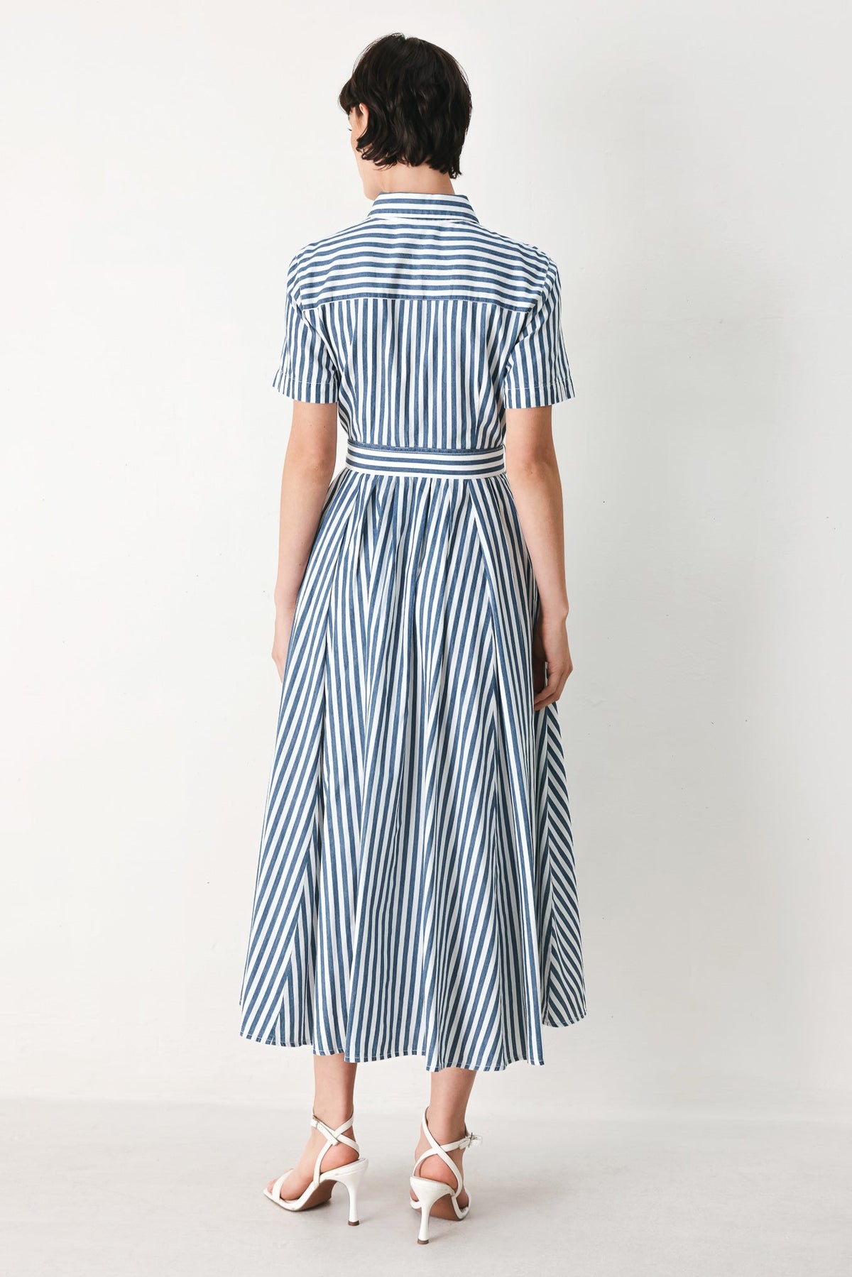 a woman in a striped dress
