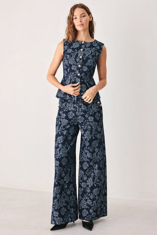 a woman in a blue floral jumpsuit