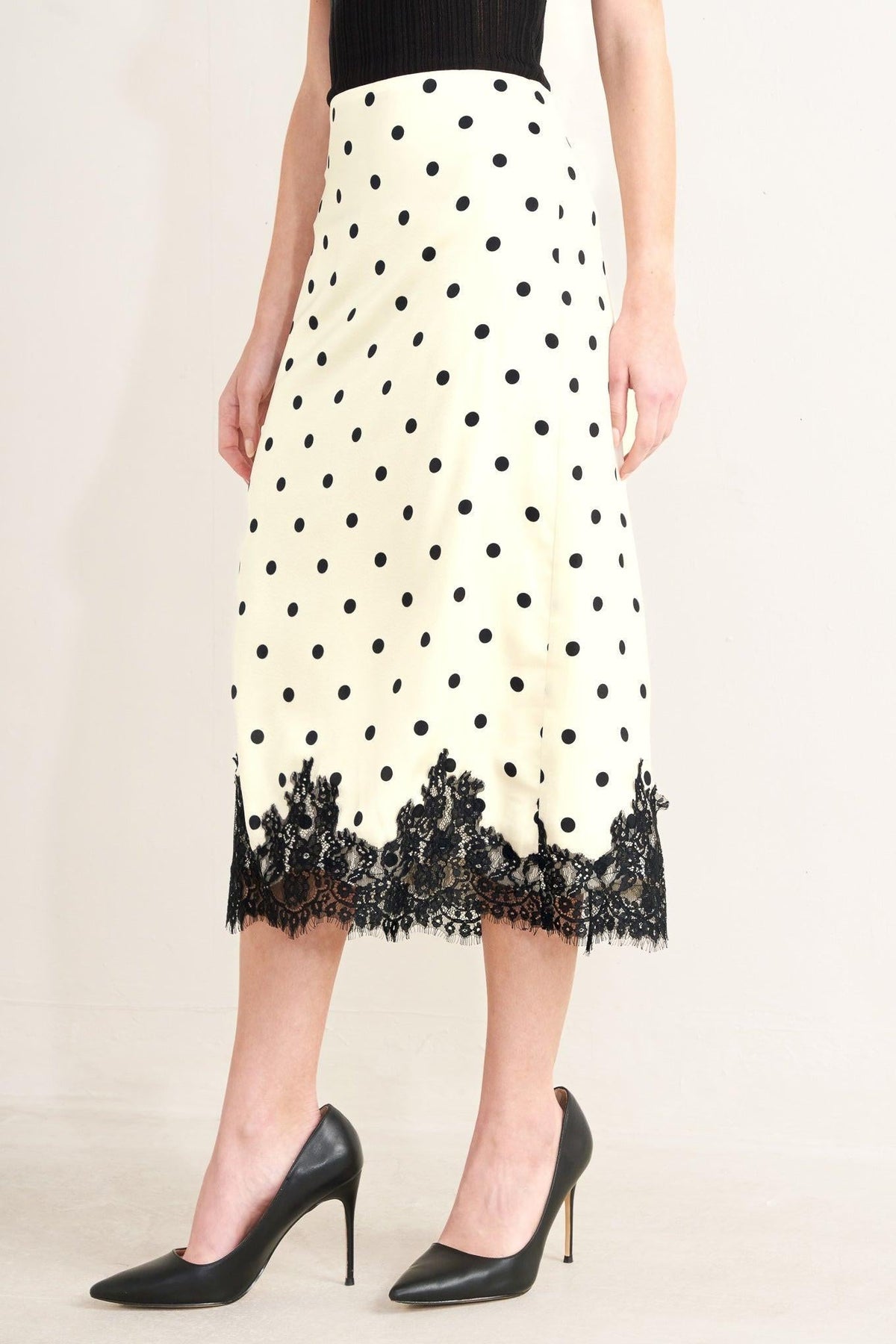 a woman wearing a polka dot skirt