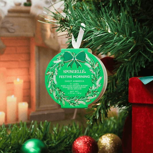 a green ornament from a christmas tree