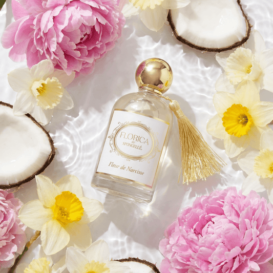 a bottle of perfume surrounded by flowers