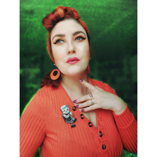 a woman with red hair and orange sweater
