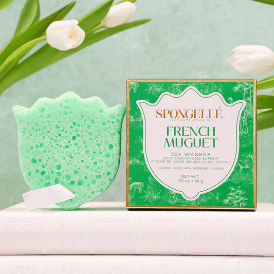 a green sponge next to a box of washcloth