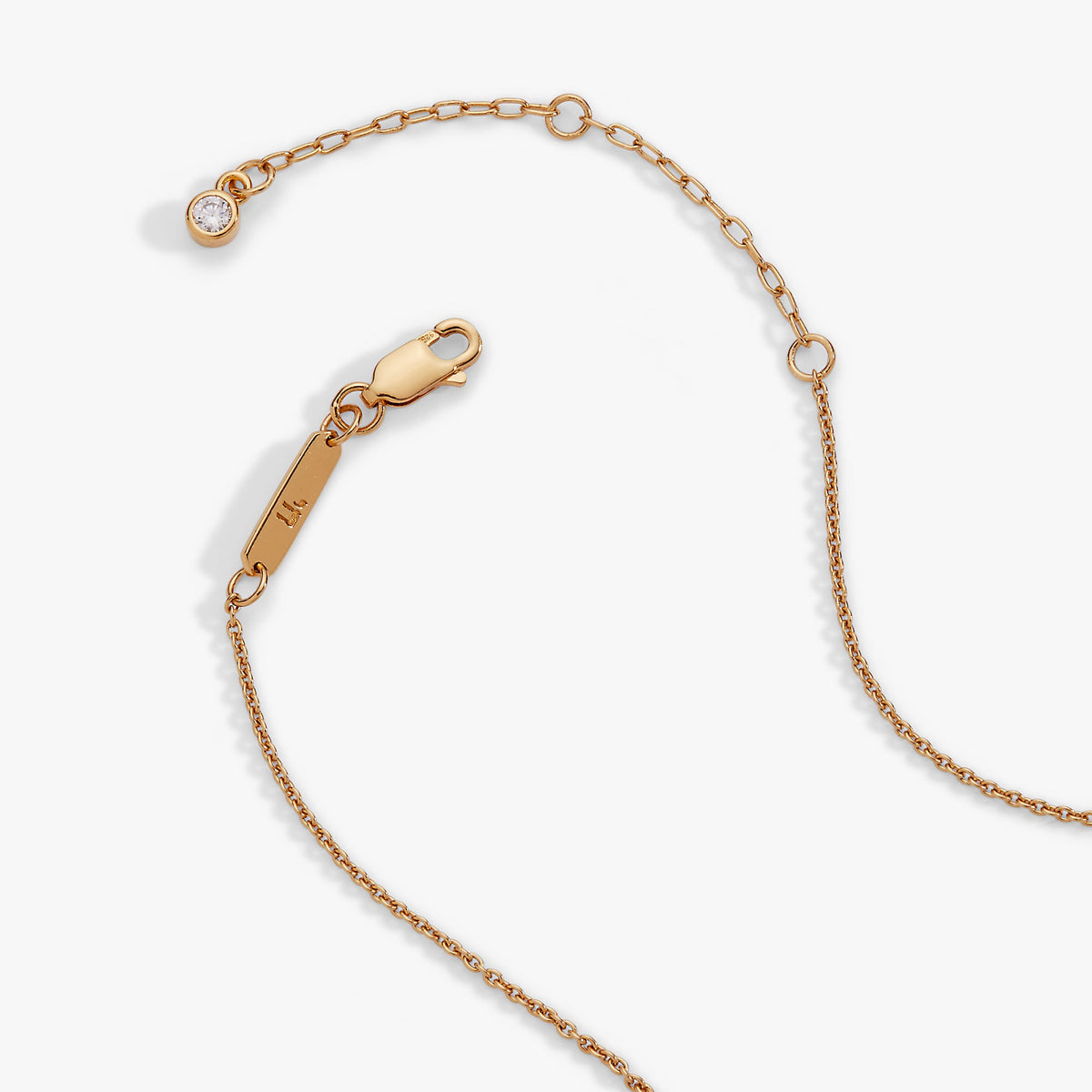 a gold chain with a diamond pendant
