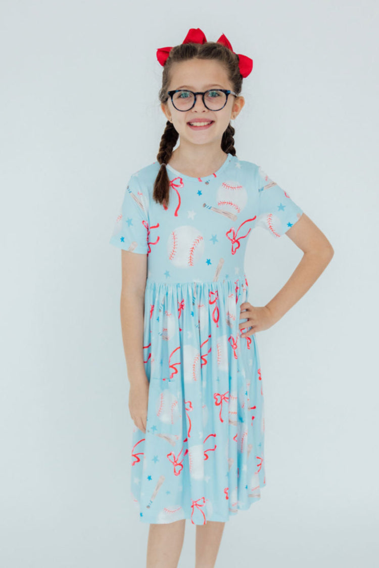 a girl wearing a dress and glasses