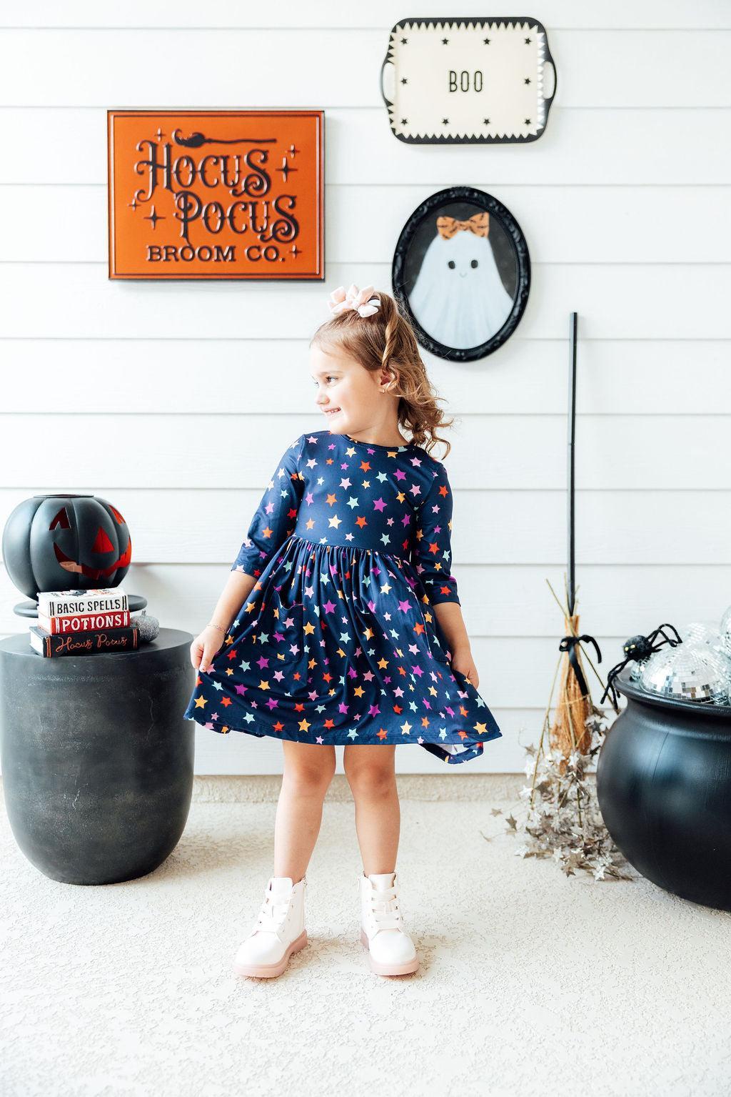 a girl in a blue dress with stars