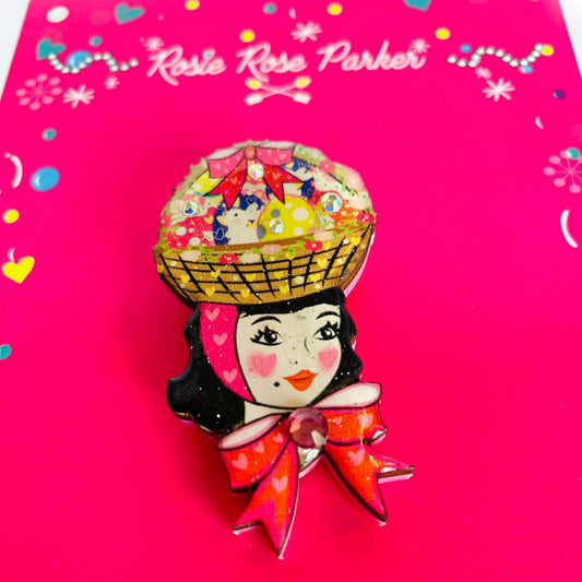 a brooch on a pink surface