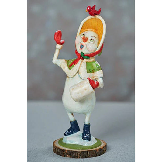 a snowman figurine on a wood stump