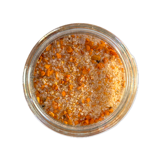 a glass container with salt and orange crystals