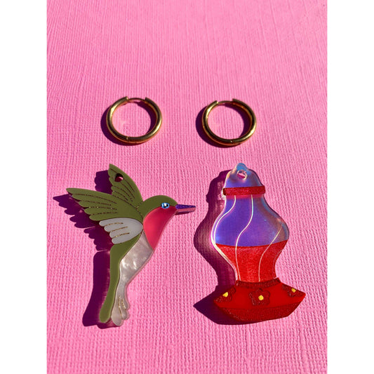 a pair of earrings and a bird