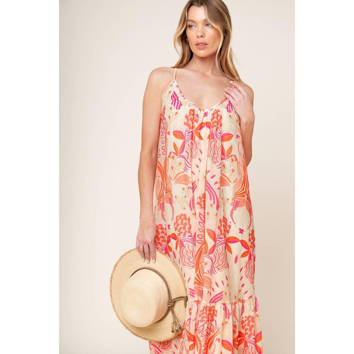 a woman in a dress holding a hat