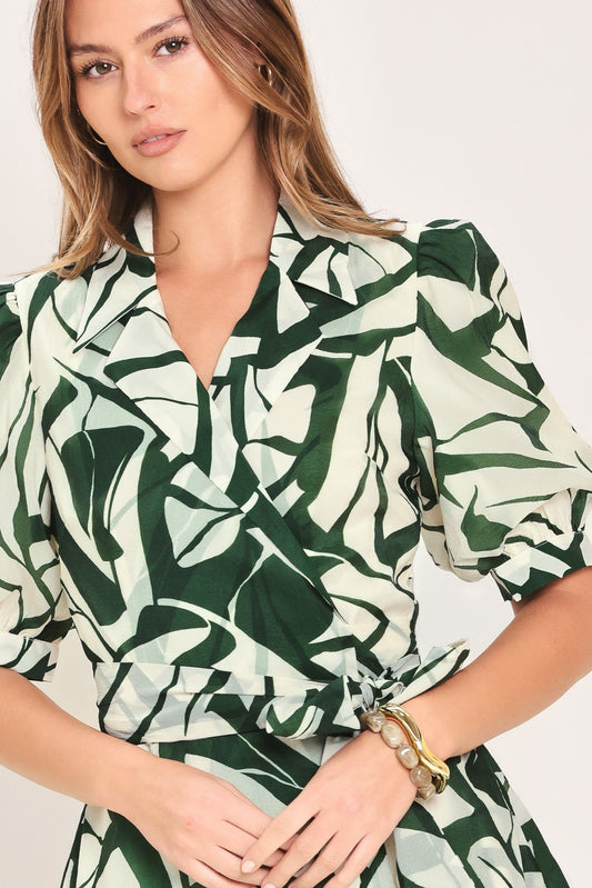 a woman in a green and white shirt