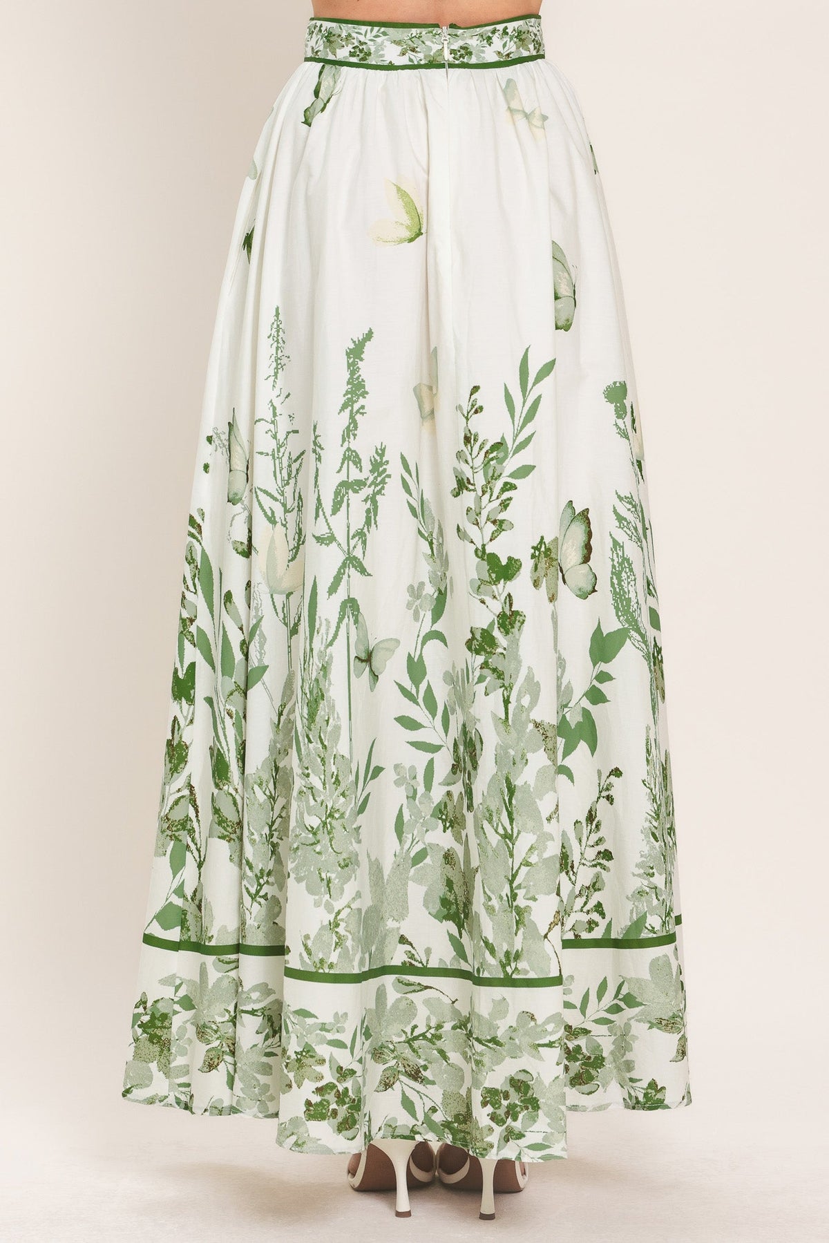 a white and green skirt with a floral design