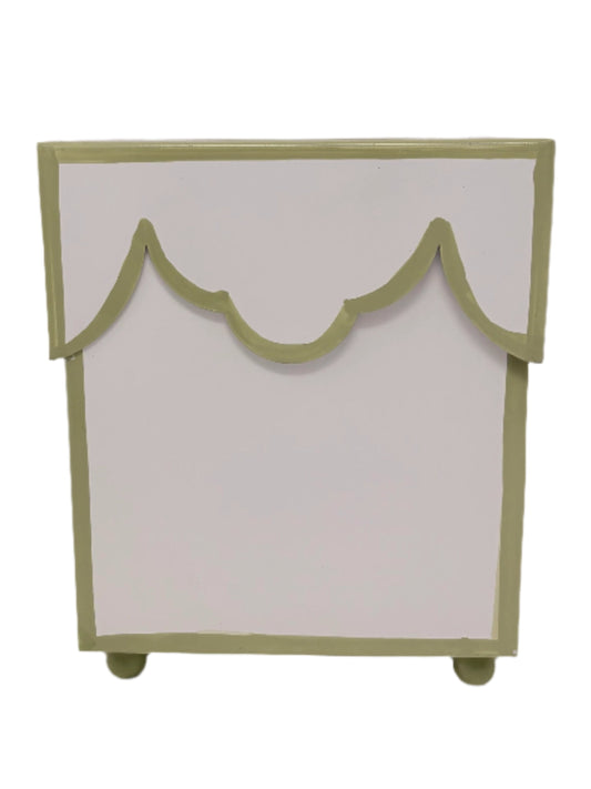 a white and green box with scalloped edges