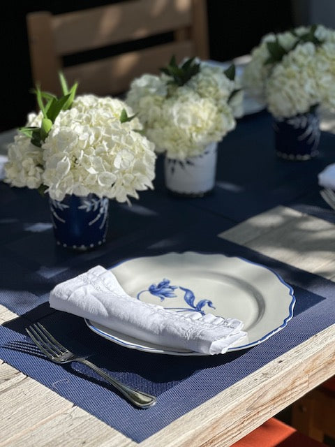 a table with a plate and flowers